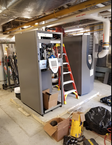 Photo of new boilers being installed at Besser Elementary School.